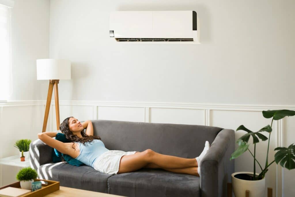woman laying on the couch in living room with air conditioning